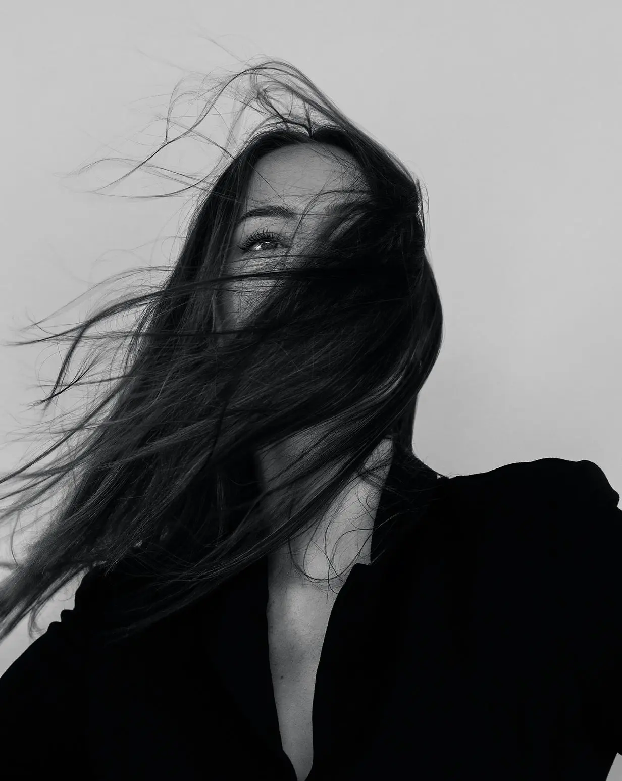 grayscale photography of woman wearing long-sleeved shirt